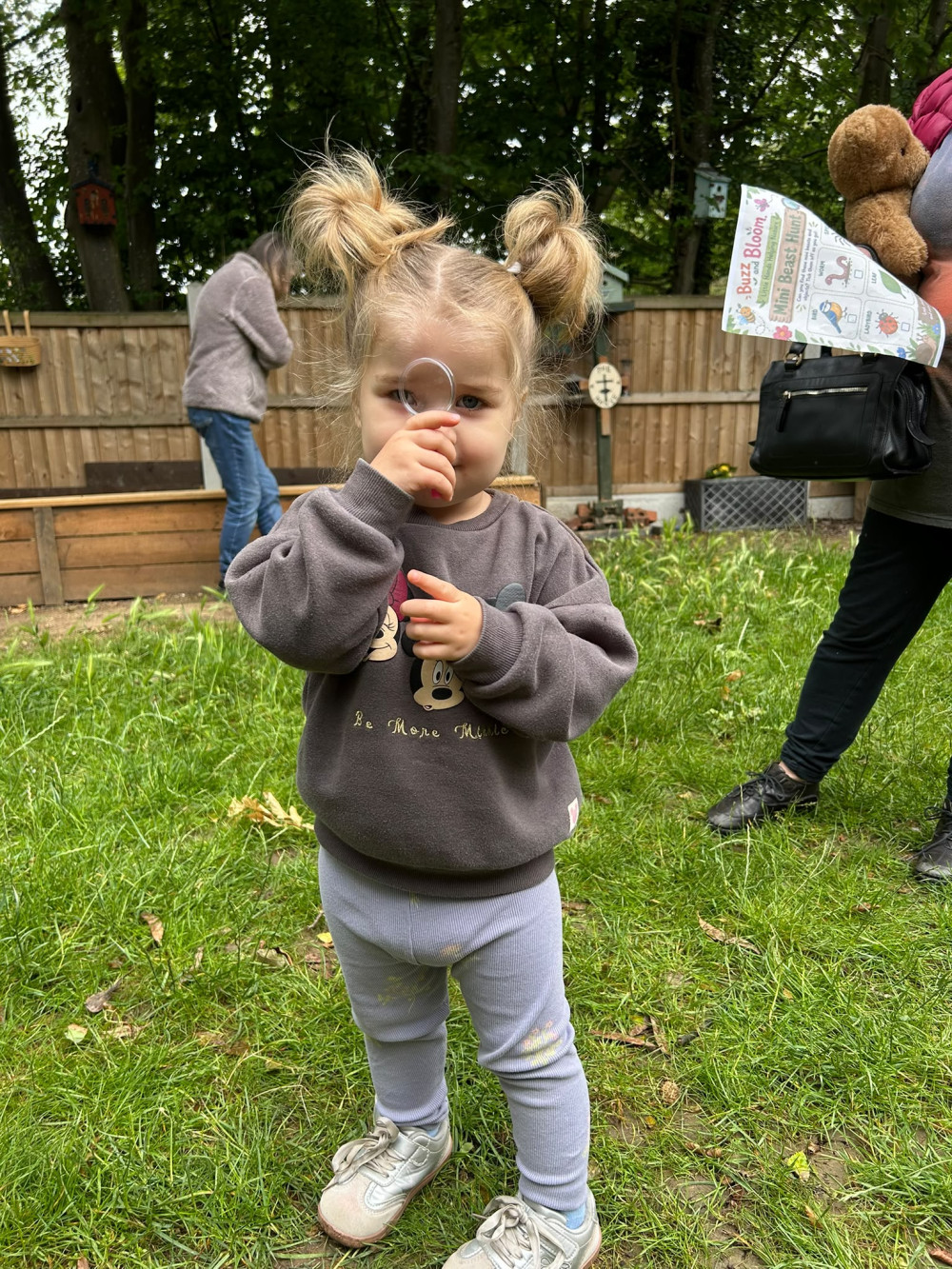 A young visitor exploring the garden with Buzz and Bloom